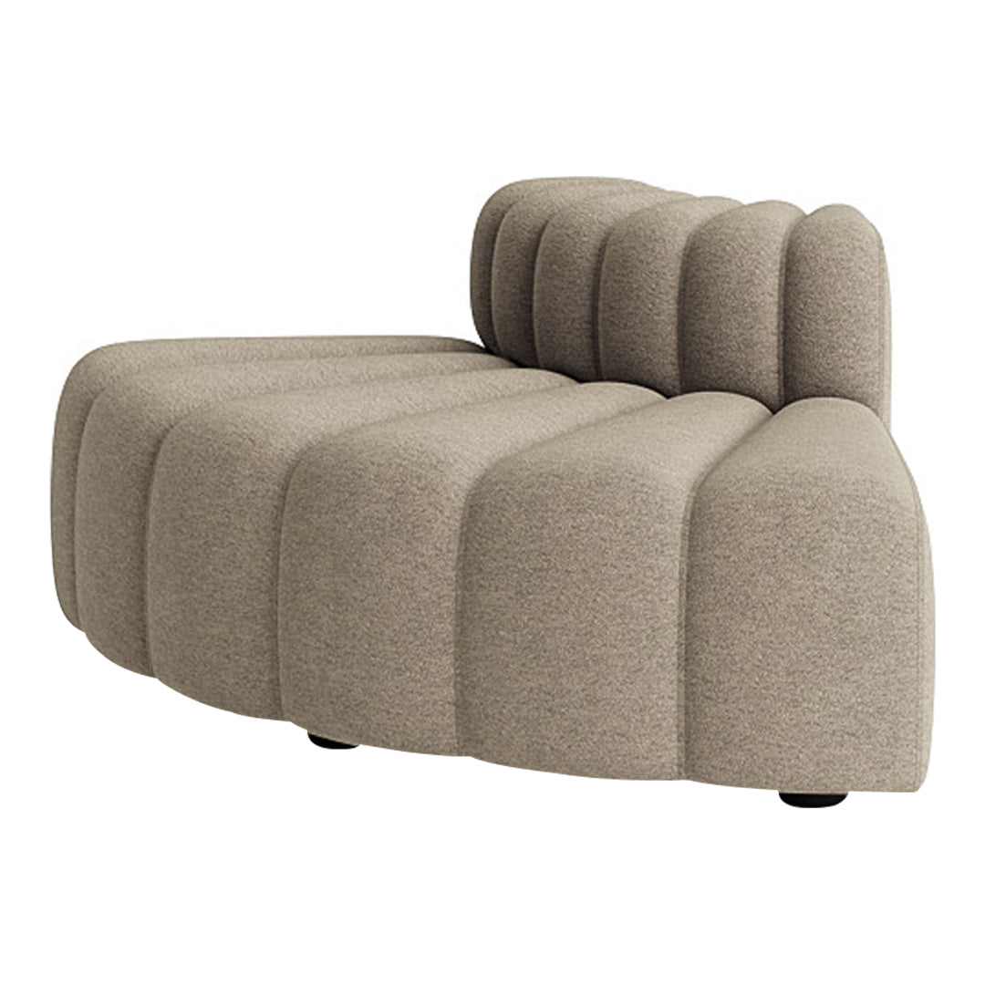 Beige curved sofa with textured, pleated pattern, featuring soft lines and a modern design. Perfect for cozy spaces.