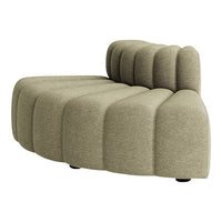 Curved, nude-toned sofa with textured, ribbed upholstery for a modern and stylish living space.