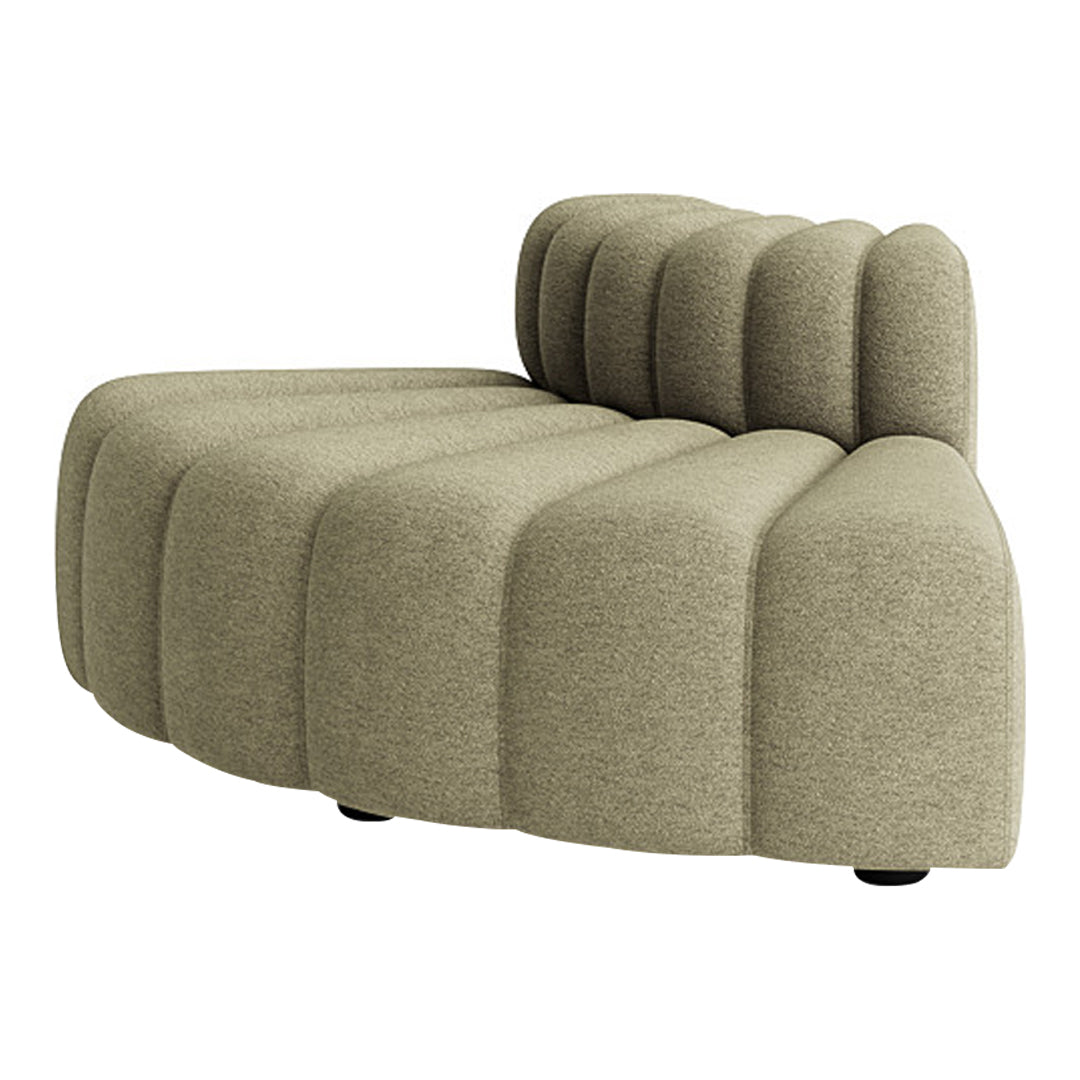 Curved, nude-toned sofa with textured, ribbed upholstery for a modern and stylish living space.
