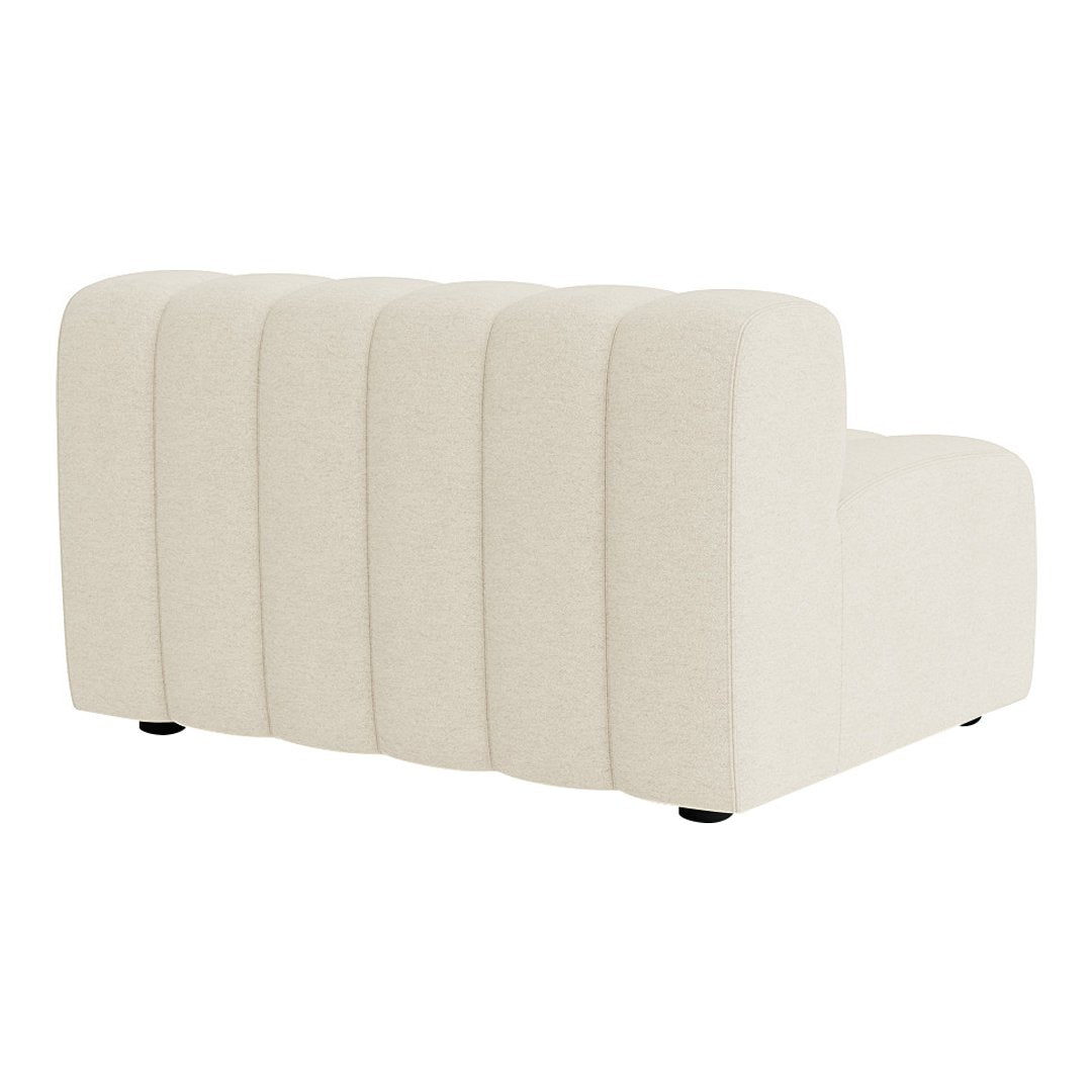 Beige curved sofa with vertical channel tufting and smooth fabric texture. Modern design suitable for any decor.