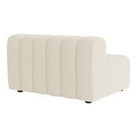 Beige curved sofa with vertical channel tufting and smooth fabric texture. Modern design suitable for any decor.