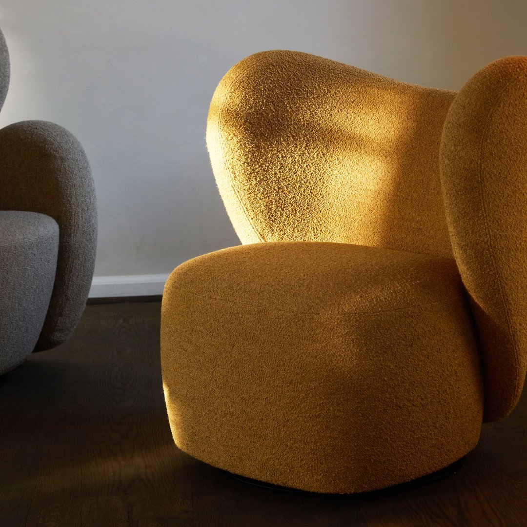 Stylish ergonomic chairs in textured gray and warm mustard yellow, showcasing modern design and cozy patterns.