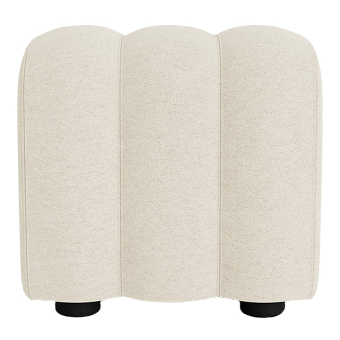 Cream-colored upholstered stool with a smooth texture and rounded design, featuring subtle seam details.