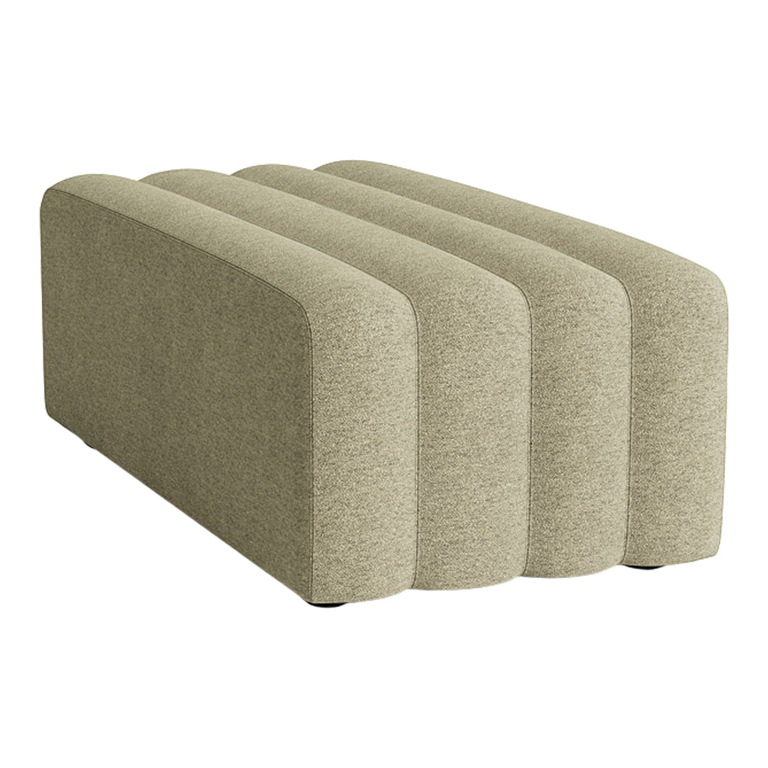 Beige upholstered furniture piece with soft, rounded edges and a textured surface, featuring a minimalist design.