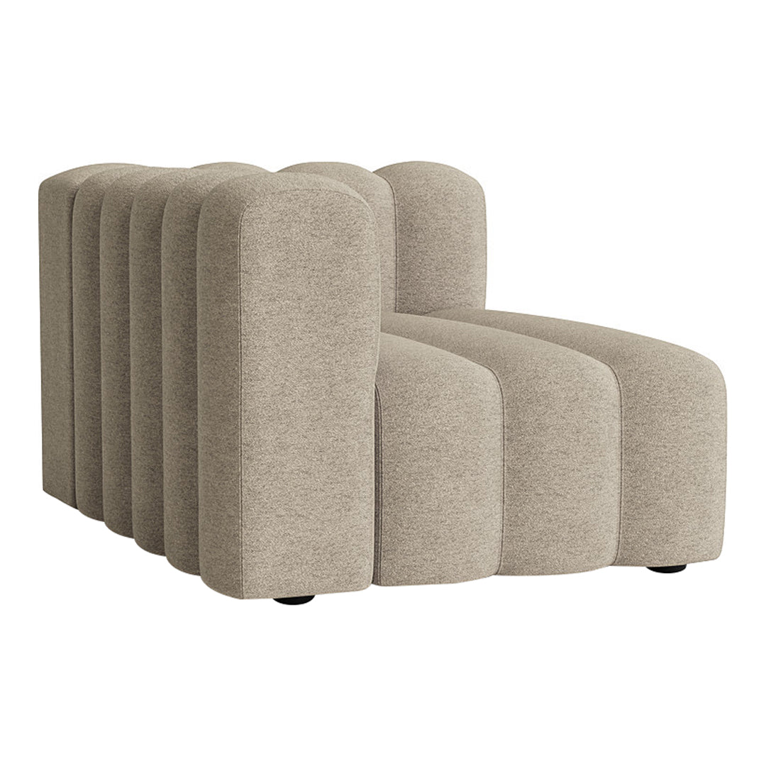 Beige modular sofa with rounded edges and a textured surface. Modern design featuring soft, neutral tones.