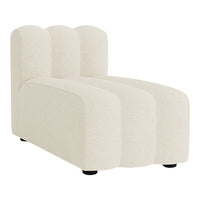 Cream-colored chaise lounge with textured fabric and a sleek, modern silhouette featuring soft, curved lines.