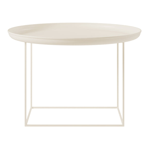 Round cream coffee table with a smooth surface and minimalist white metal frame. Stylish and modern design.
