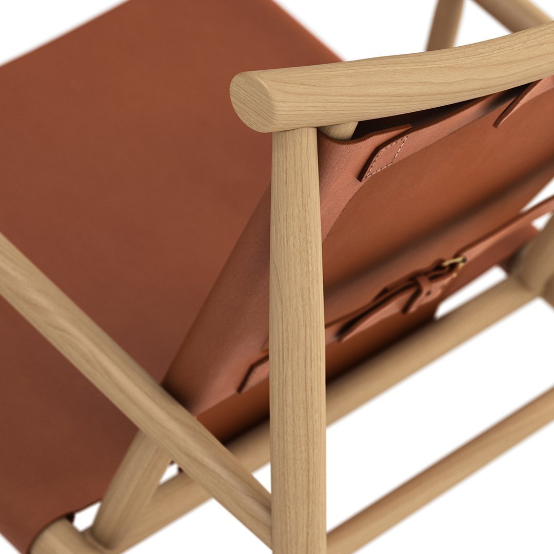 Tan leather chair with natural wood frame, featuring smooth textures and a minimalist design.