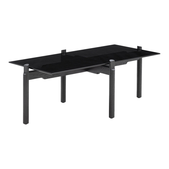 Modern black glass dining table with sleek black legs and minimalist design, perfect for contemporary interiors.