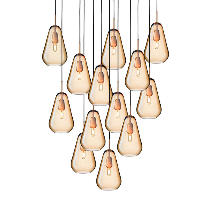 Multiples of amber teardrop pendant lights with black accents, creating a warm and modern ambiance.