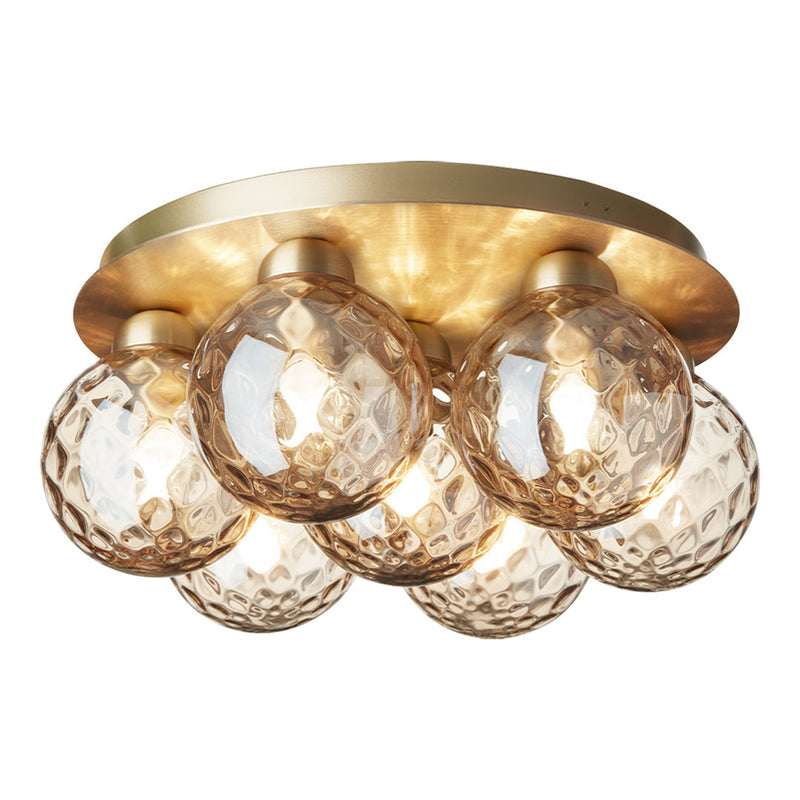 Brass ceiling light fixture with six textured glass globes in amber hues, featuring a modern geometric pattern.