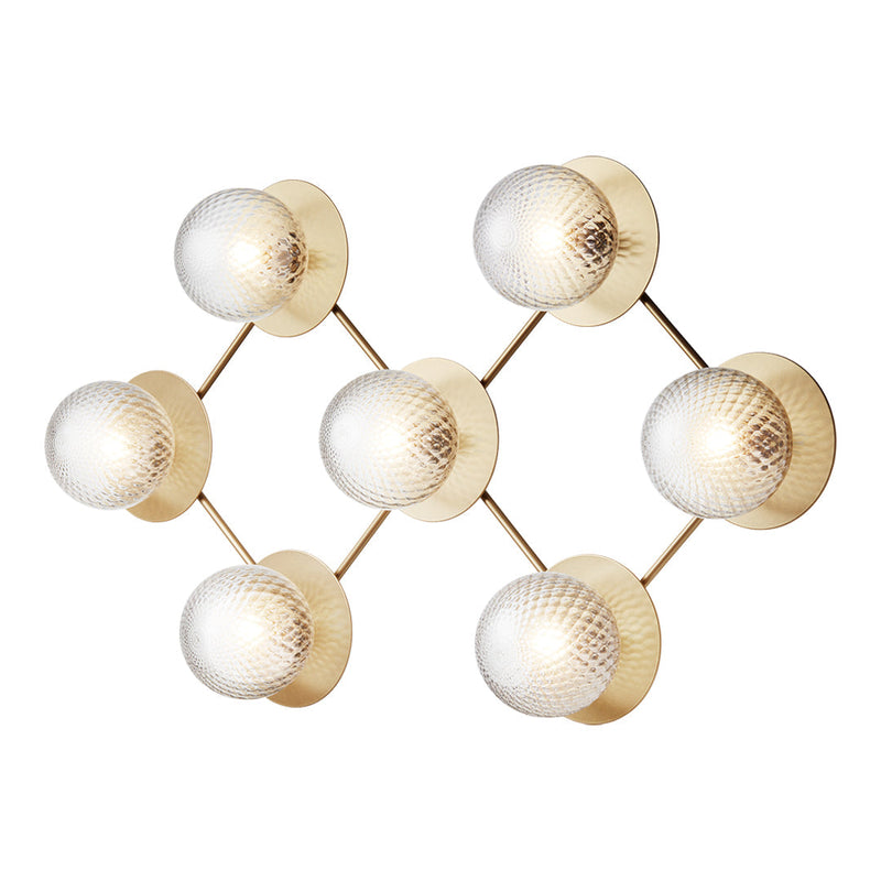 Gold and glass wall light with six spherical shades and geometric pattern, adding elegance to modern decor.