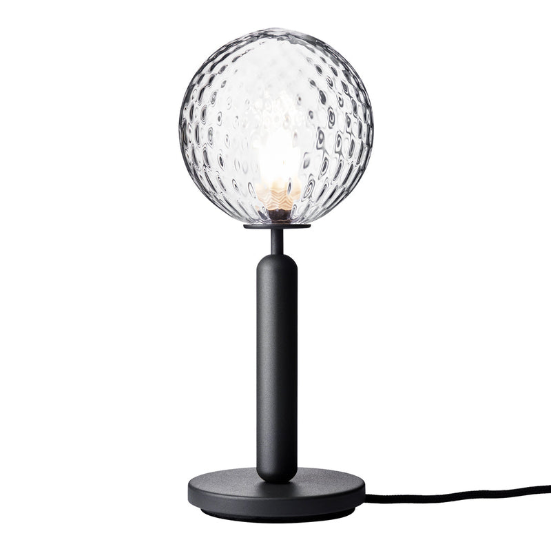 "Textured clear glass lamp with a black metal base and stand, featuring a geometric pattern."