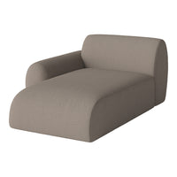 Beige upholstered chaise lounge with a smooth, textured fabric and modern curved design. Perfect for any living space.
