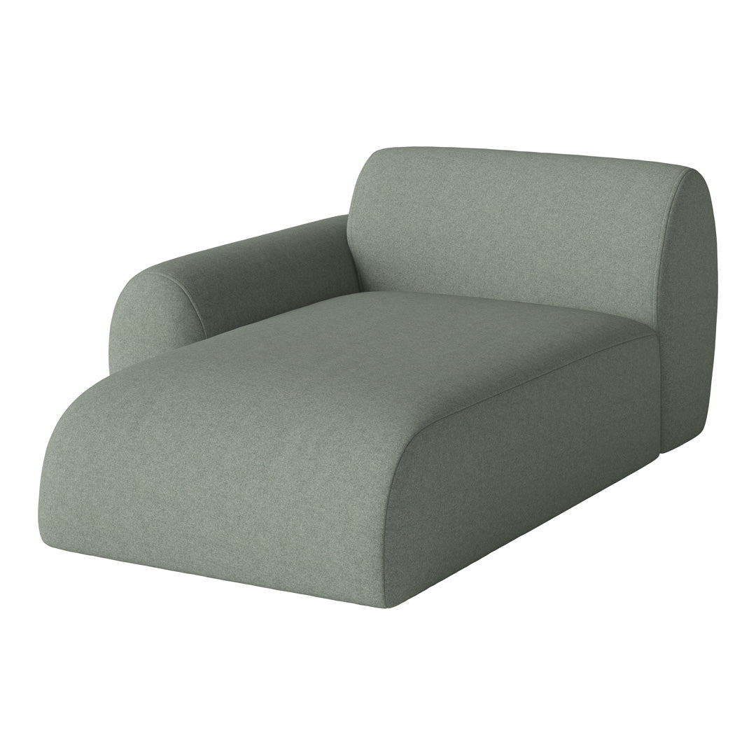 Soft green chaise lounge in a minimalist design, featuring a smooth, textured fabric finish. Ideal for modern decor.