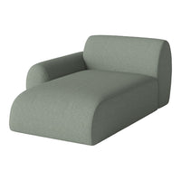 Soft green chaise lounge in a minimalist design, featuring a smooth, textured fabric finish. Ideal for modern decor.