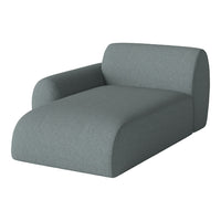 Sleek, modern chaise lounge in soft, muted gray fabric with a smooth, solid color finish.