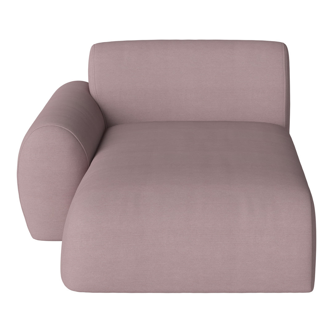 Plush chaise lounge in soft pastel pink with subtle ribbed texture for added elegance and style.