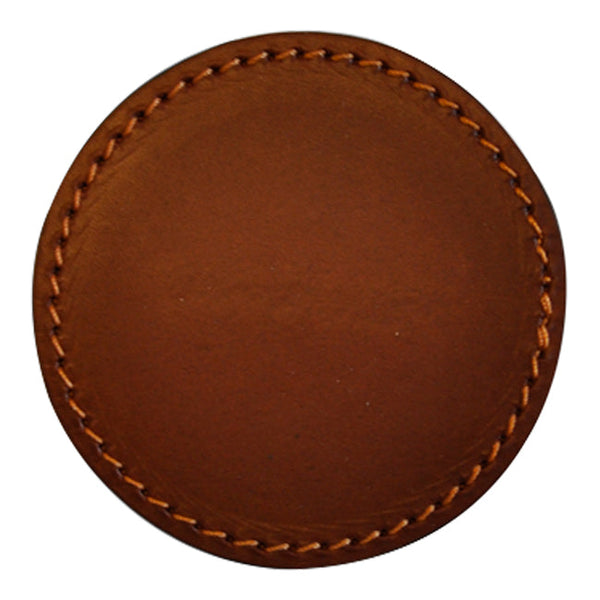 Round leather coaster in warm brown with subtle texture and contrasting golden stitching. Perfect for any table setting.