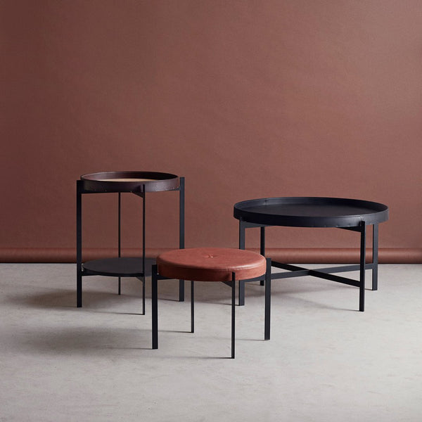 Set of three modern coffee tables featuring a black metal frame, rust-colored tabletops, and a minimalist design.