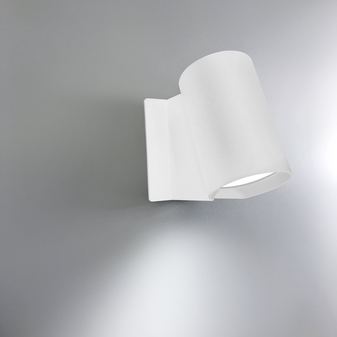 Modern white wall lamp with a sleek, curved design and smooth matte finish. Ideal for contemporary decor.