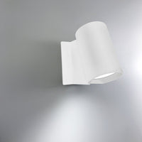 Modern white wall lamp with a sleek, curved design and smooth matte finish. Ideal for contemporary decor.