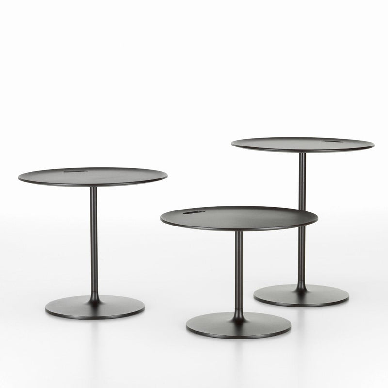 Set of three minimalist round black side tables with sleek, modern bases. Ideal for contemporary decor.