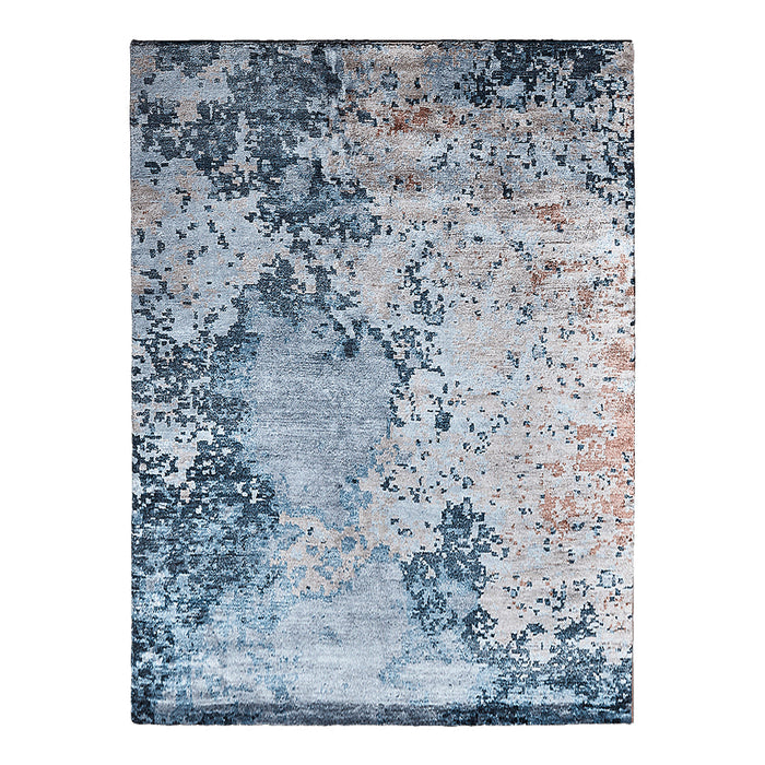 Abstract blue and gray area rug with textured patterns and hints of copper accents. Perfect for modern decor.