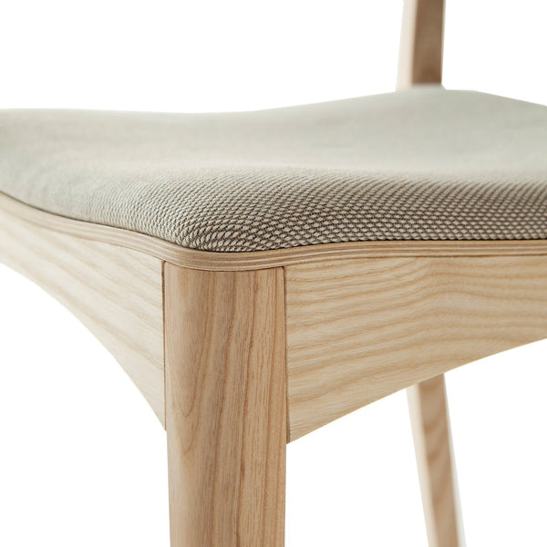 Light beige fabric seat with a textured grid pattern, complemented by natural wood grain frame.