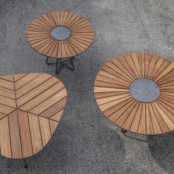 "Three wooden coffee tables featuring radial patterns and a central gray accent, showcasing natural wood tones."