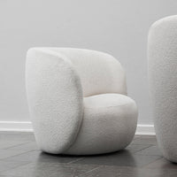 White textured armchair with a modern, rounded design, featuring a cozy boucle fabric finish.