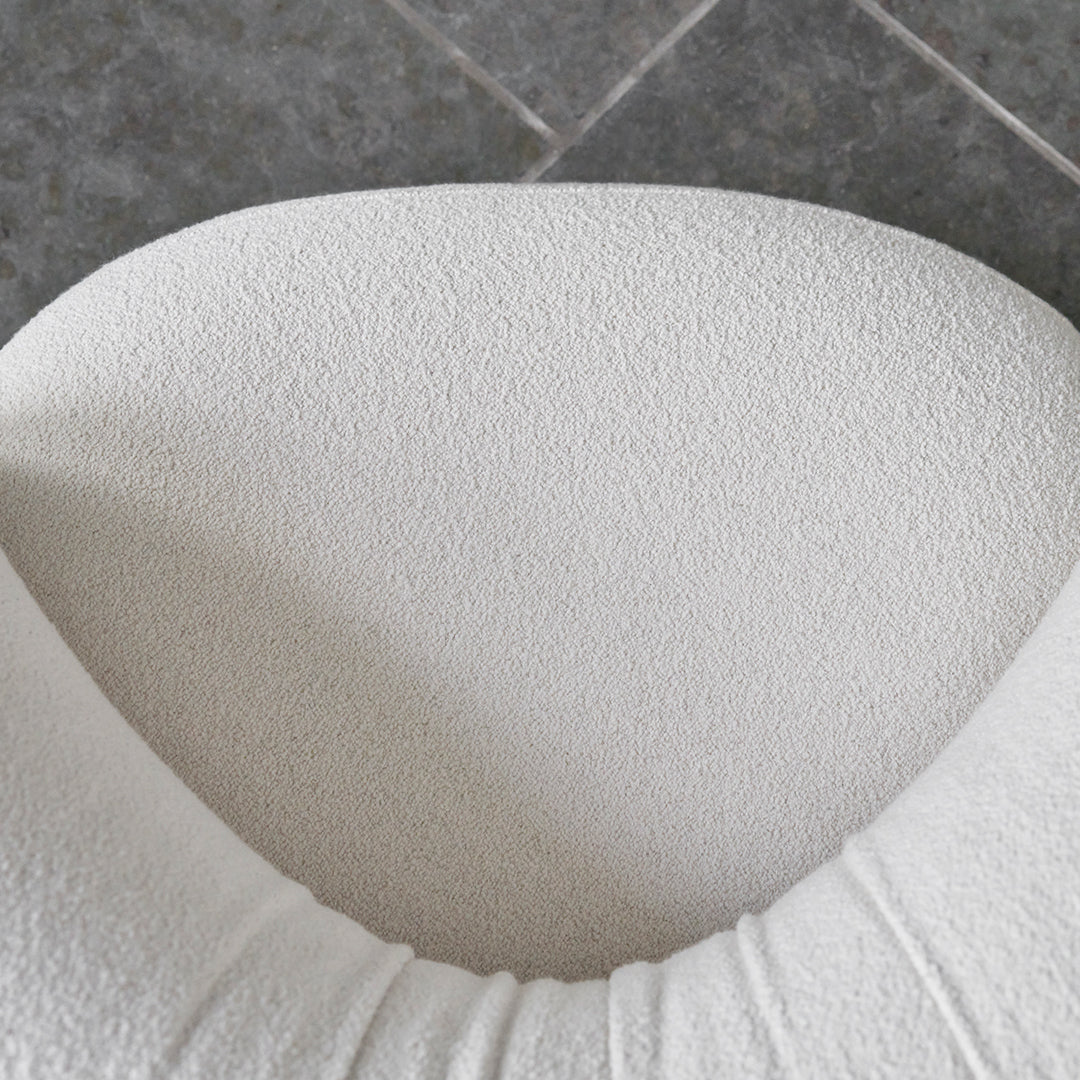 Textured white upholstery with a soft, plush finish, featuring subtle grooves and a modern, minimalist design.