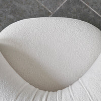 Textured white upholstery with a soft, plush finish, featuring subtle grooves and a modern, minimalist design.