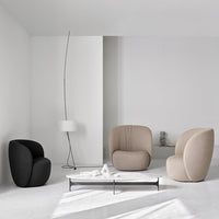 Black and beige modern armchairs with textured upholstery in a minimalist white interior.