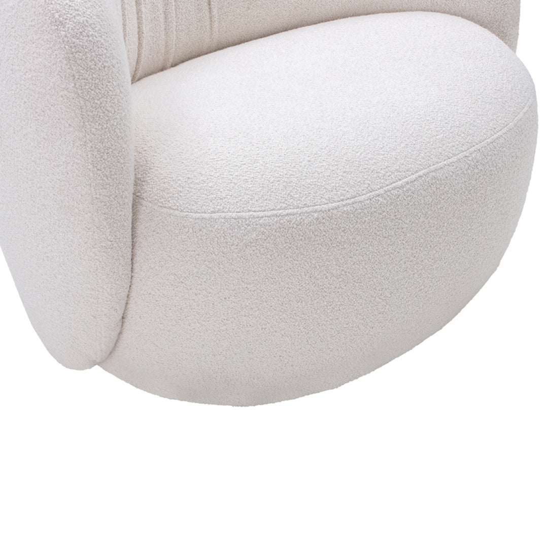 Textured cream upholstery with a smooth, rounded design. Elegant and modern accent chair detail.