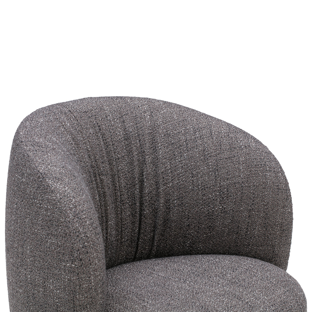 Curved gray upholstered armchair featuring a textured pattern for a modern look. Perfect for contemporary interiors.