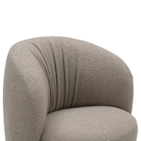 Soft beige upholstered chair with a rounded shape and tufted texture, perfect for modern decor.