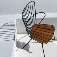 Black metal chair with curved lines and a brown slatted wooden seat, set against a white background.