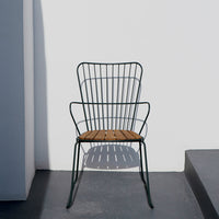 Black metal chair with a wooden seat, featuring a modern, minimalistic design against a white background.