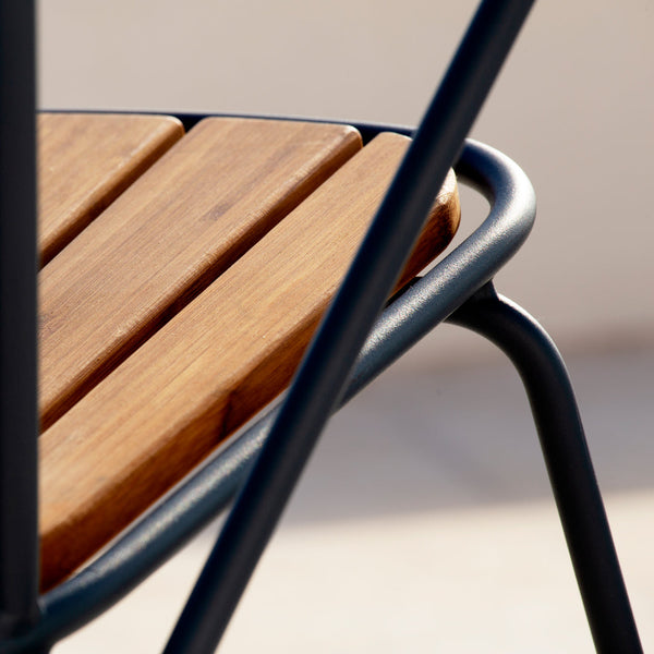 Brown wooden slats contrasted with a sleek black metal frame, highlighting modern design and natural textures.