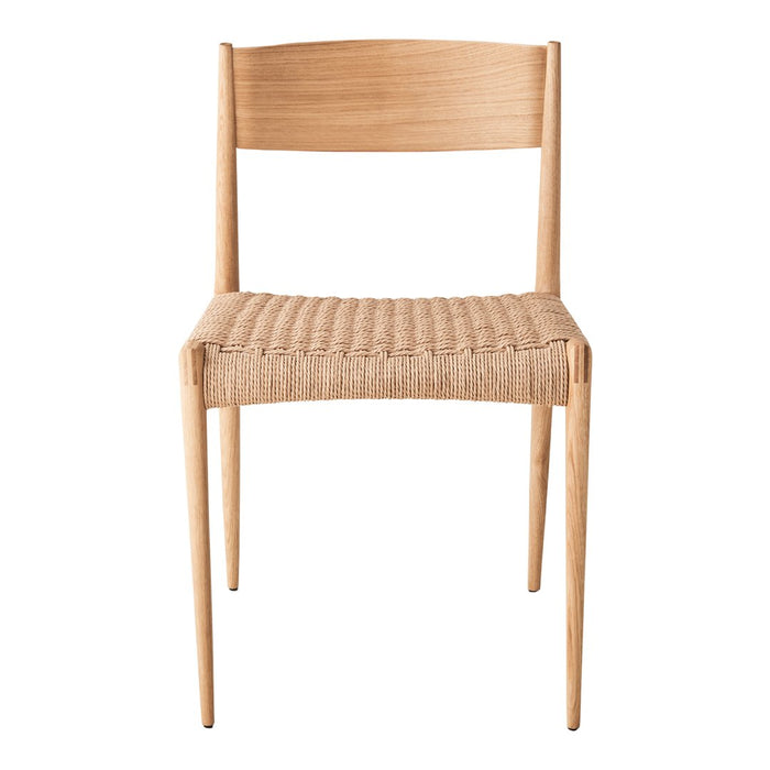 Natural wood chair with a woven straw seat, showcasing a minimalist design in neutral tones.