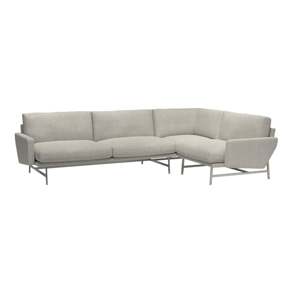 Light gray sectional sofa with smooth, textured fabric and sleek, modern metal legs. Ideal for contemporary living spaces.
