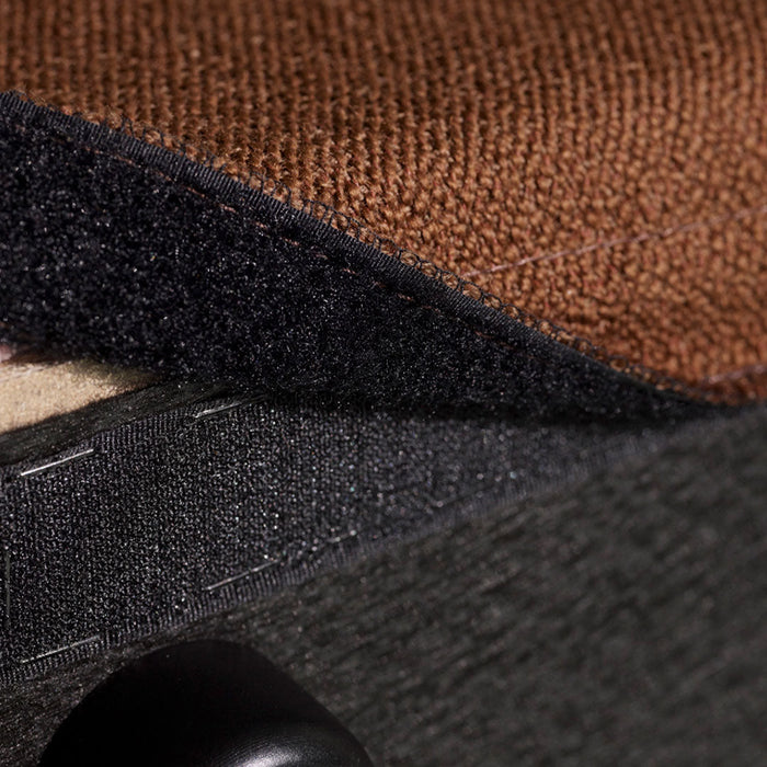 Textured fabric layers in rich brown, navy blue, and charcoal gray, showcasing diverse patterns and finishes.