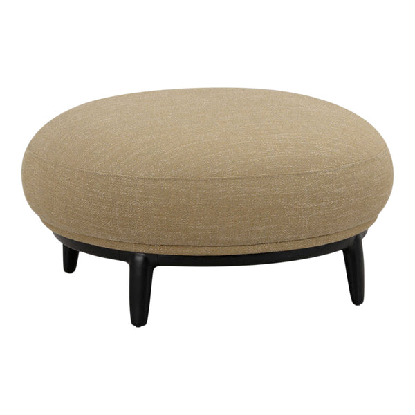 Round ottoman in a soft beige fabric with a smooth texture, set on black legs for modern contrast.
