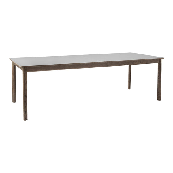 Rectangular dining table with a sleek gray surface and metallic legs, featuring a minimalist design.