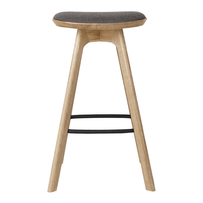 Light wood bar stool with a gray upholstered seat and black metal footrest, featuring a sleek, modern design.