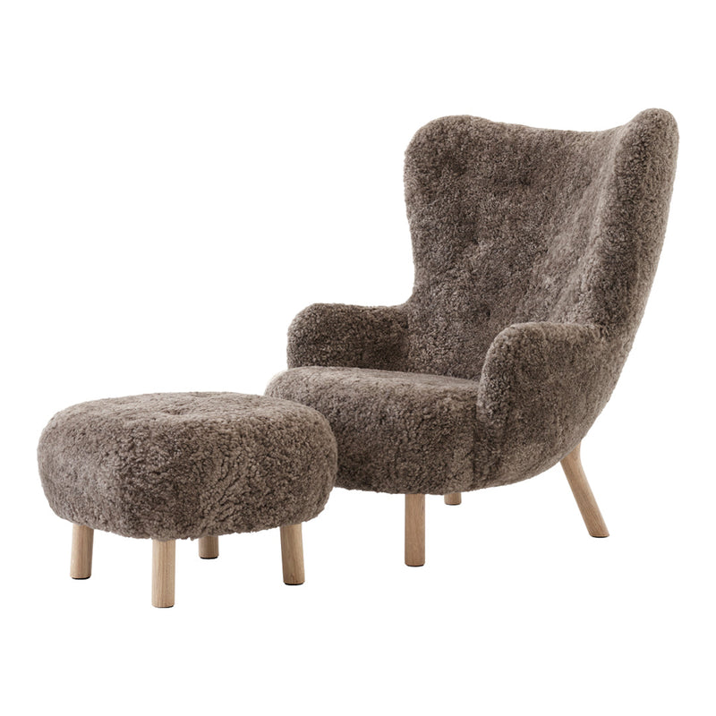 Cozy brown faux fur armchair and pouf with natural wooden legs, featuring a modern, textured pattern.