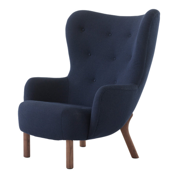 Navy blue upholstered wingback chair with tufted detailing and wooden legs, blending modern elegance with cozy comfort.