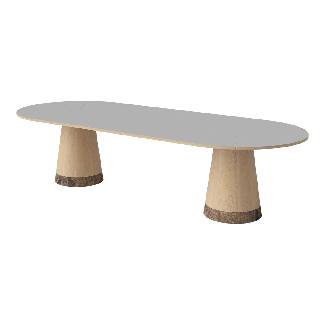Light gray oval table with natural wood base featuring contrasting dark round accents. Modern minimalist design.