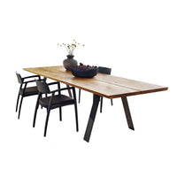 Stylish wooden dining table with a natural finish and sleek black chairs, featuring a minimalist design.